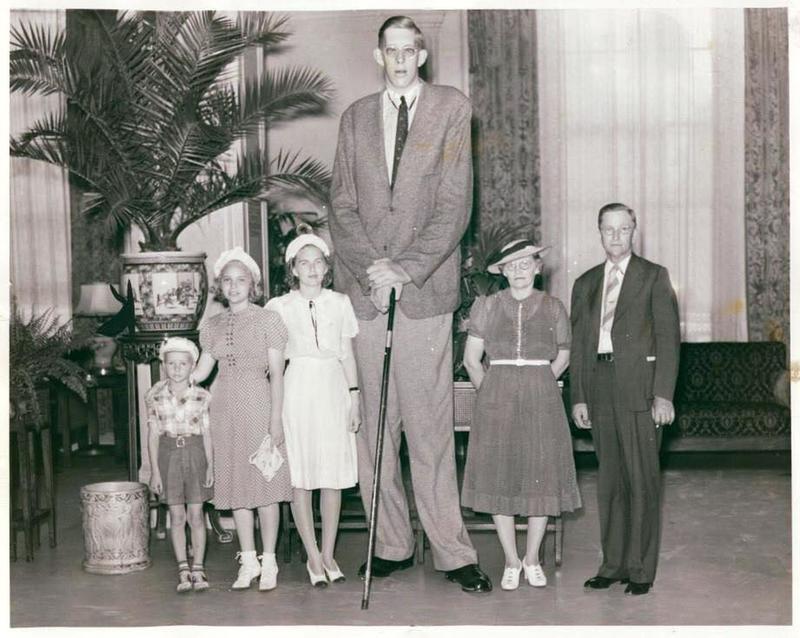 The world's tallest man, Robert Wadlow at age 21 standing with his family, 1939