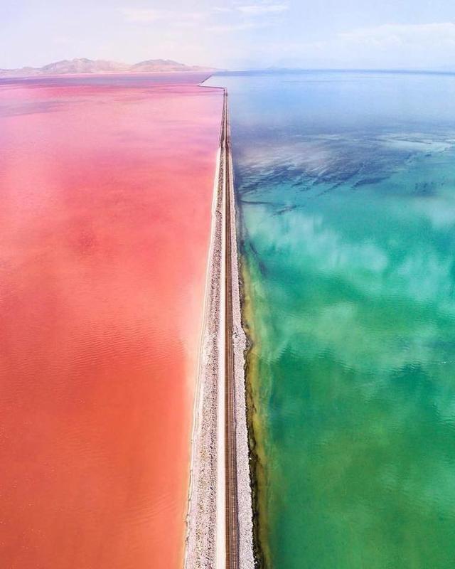 A causeway separates the Great Salt Lake in Utah. The two sections of the lake are colored differently from unique bacteria living on each side.