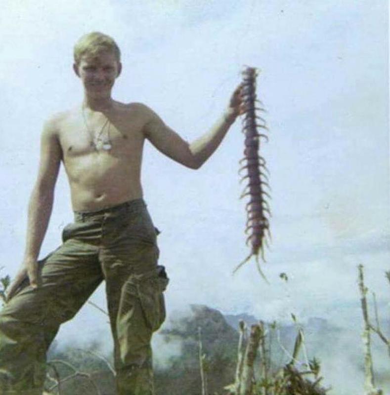 A Vietnam Soldier holding a jungle centipede in Vietnam, 1967